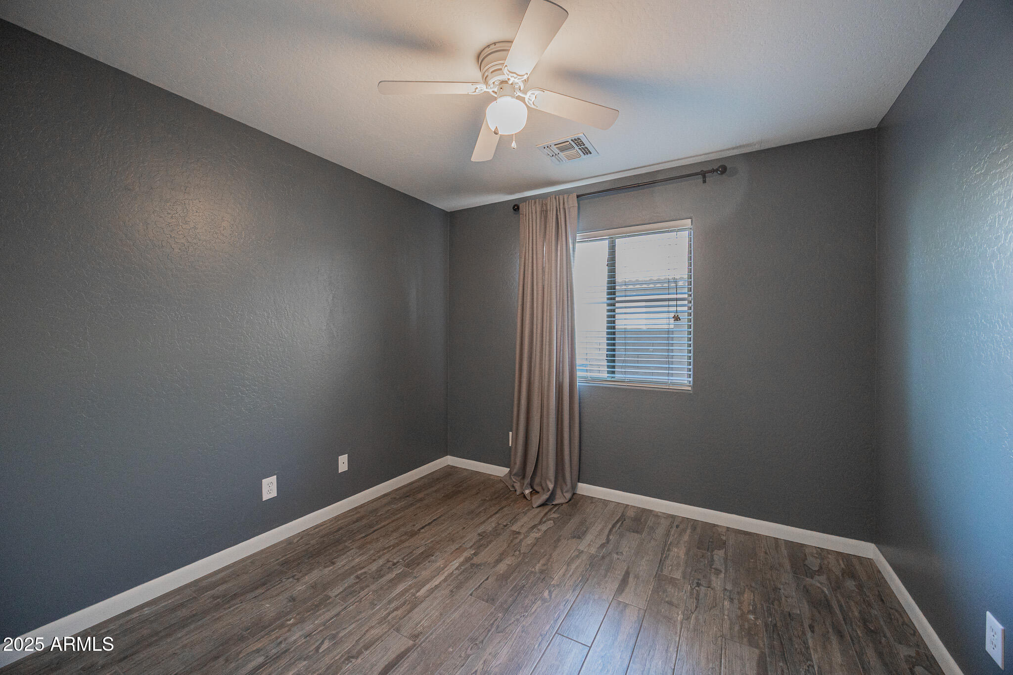 1633 East Beautiful Lane Phoenix, AZ 85042 - Photo 20 of 27 wooden floor in an empty room with a window