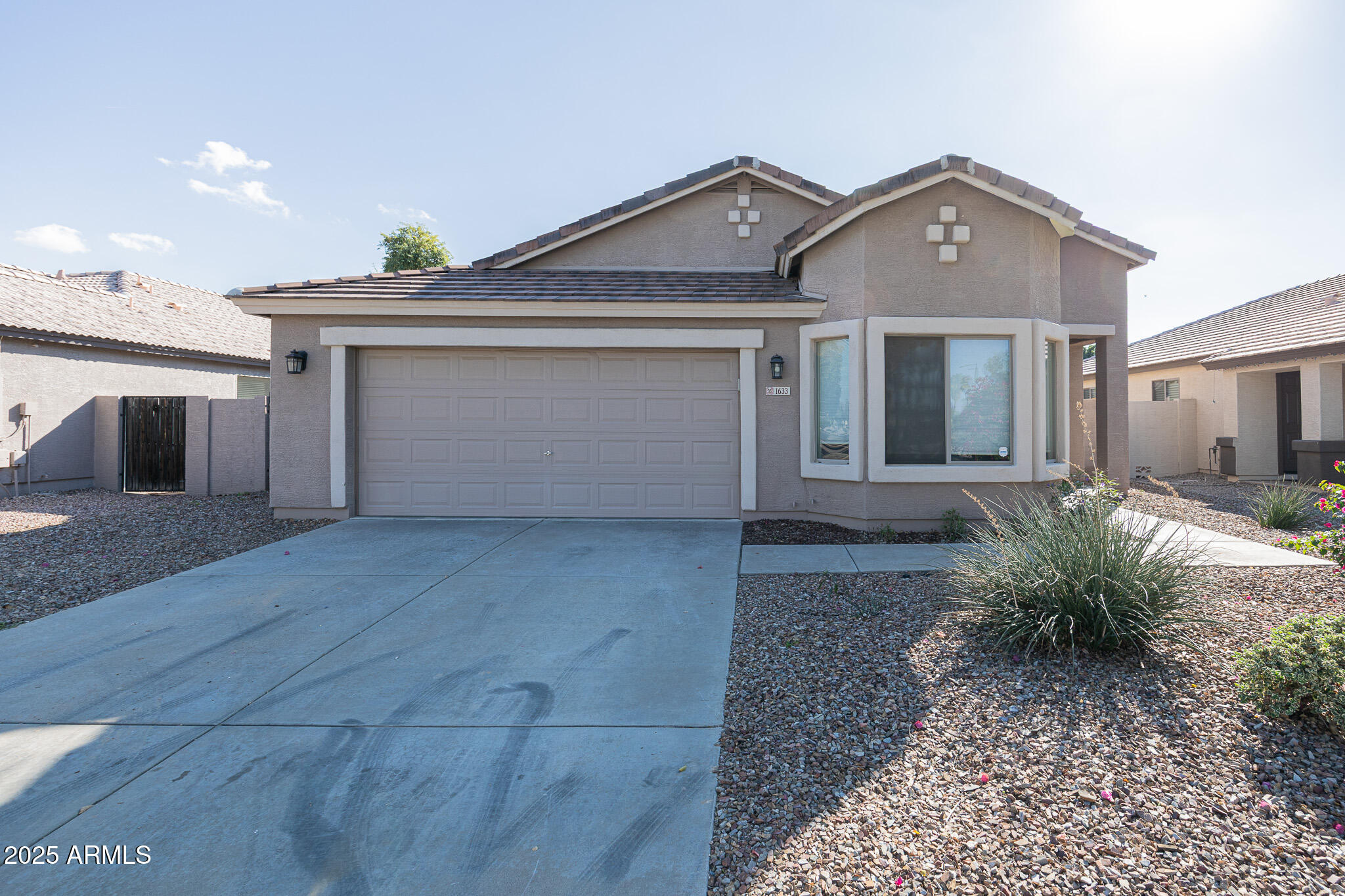 1633 East Beautiful Lane Phoenix, AZ 85042 - Photo 2 of 27 a front view of a house with garden