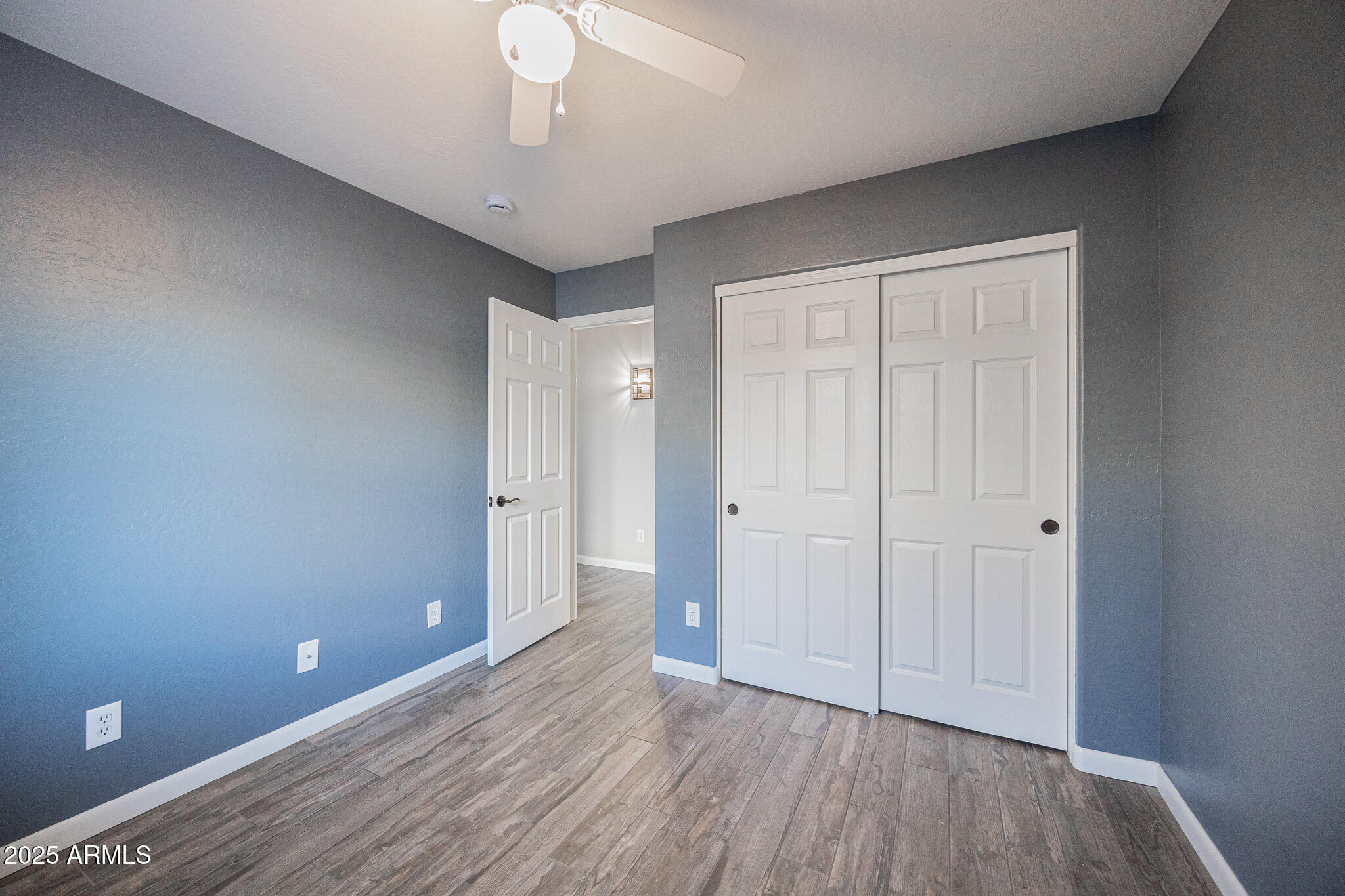 1633 East Beautiful Lane Phoenix, AZ 85042 - Photo 21 of 27 a view of an empty room with wooden floor