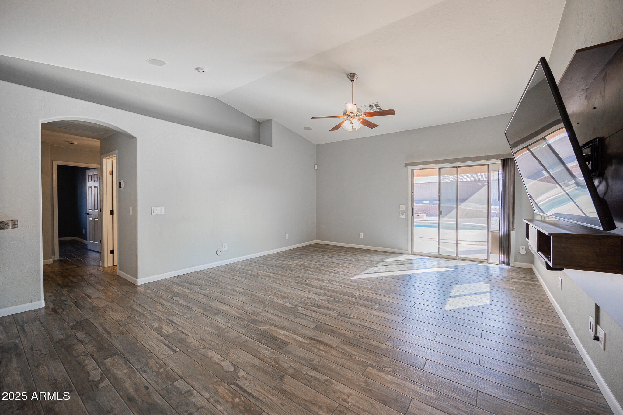 1633 East Beautiful Lane Phoenix, AZ 85042 - Photo 4 of 27 wooden floor in an empty room with a window
