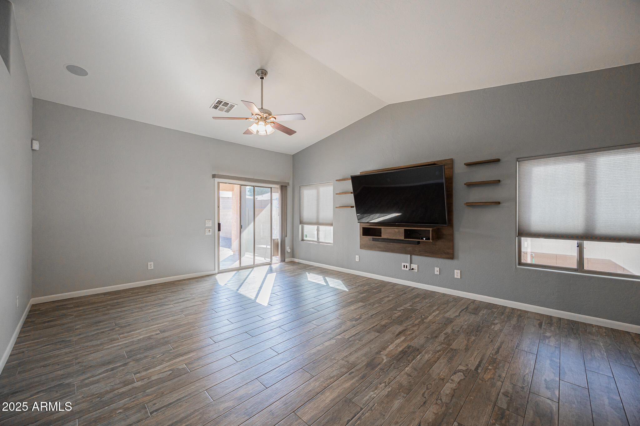 1633 East Beautiful Lane Phoenix, AZ 85042 - Photo 5 of 27 a view of a livingroom with wooden floor and a flat screen tv