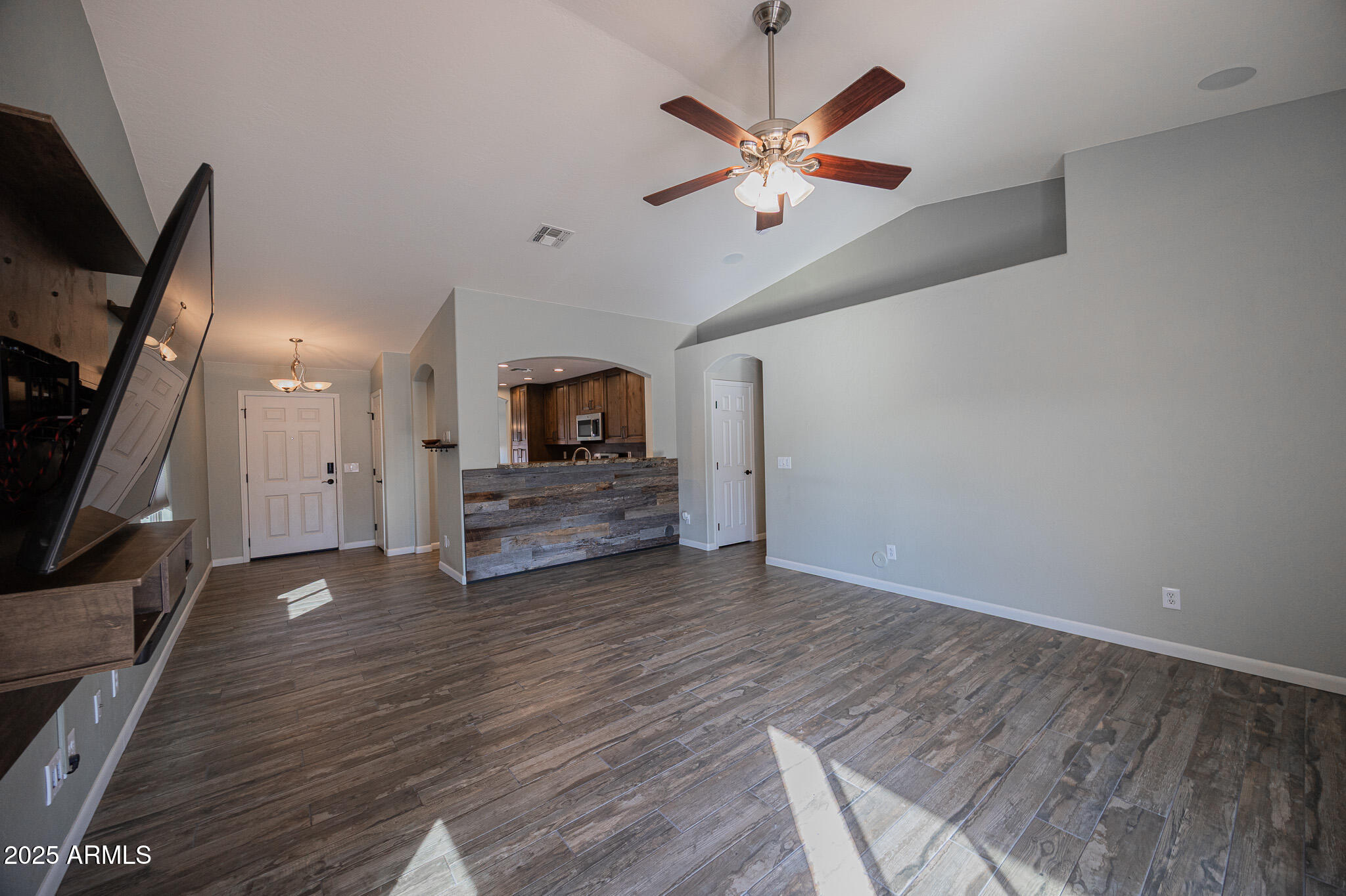 1633 East Beautiful Lane Phoenix, AZ 85042 - Photo 7 of 27 wooden floor in an empty room with a fireplace