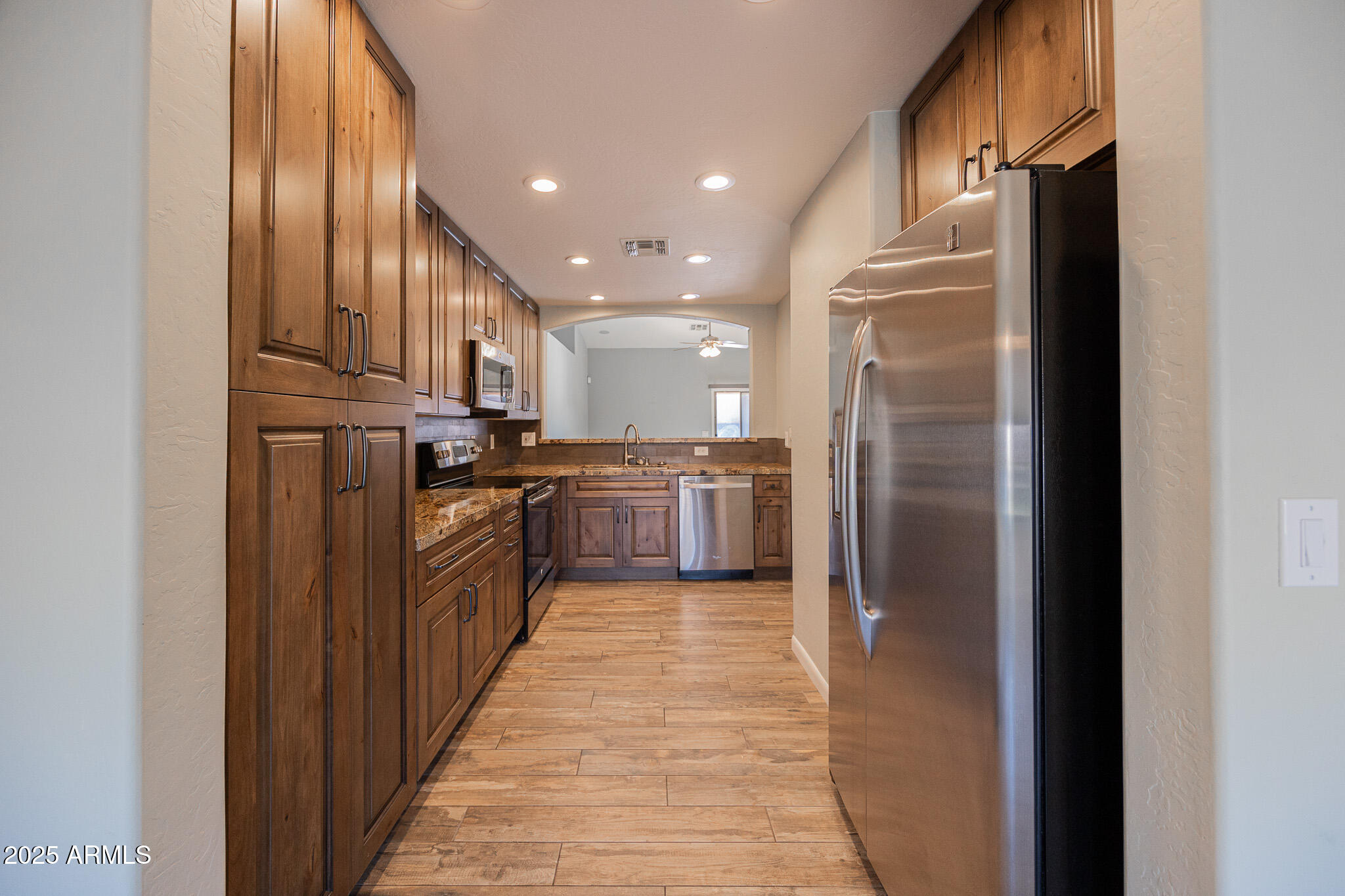 1633 East Beautiful Lane Phoenix, AZ 85042 - Photo 10 of 27 a kitchen with stainless steel appliances granite countertop a refrigerator and a sink