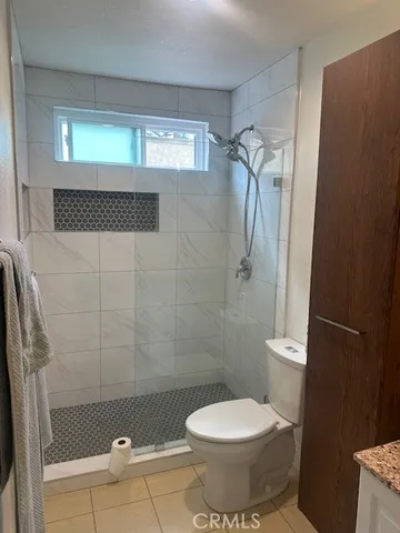a bathroom with a granite countertop sink a mirror and a vanity