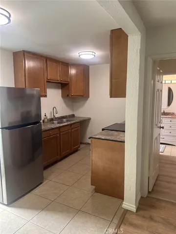 a kitchen with stainless steel appliances granite countertop a refrigerator and a stove