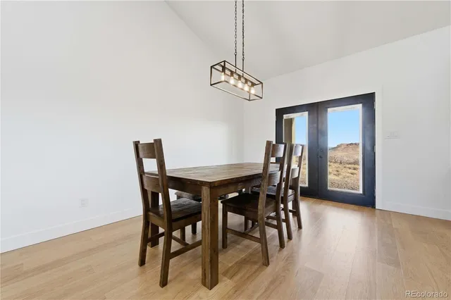 a kitchen with stainless steel appliances granite countertop wooden floors a stove and a sink