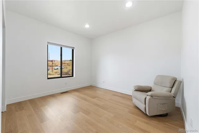 a view of an empty room with toys and closet