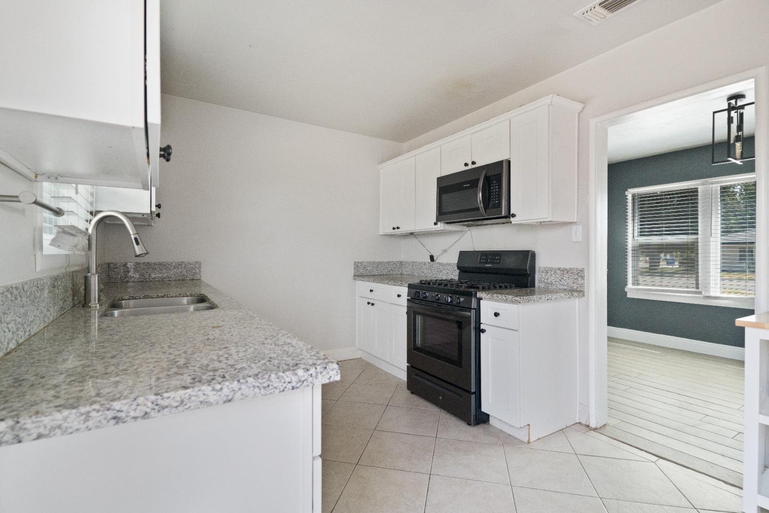 1900 Easy Street Hanford, CA 93230 - Photo 15 of 23 a kitchen with stainless steel appliances granite countertop a sink stove and microwave