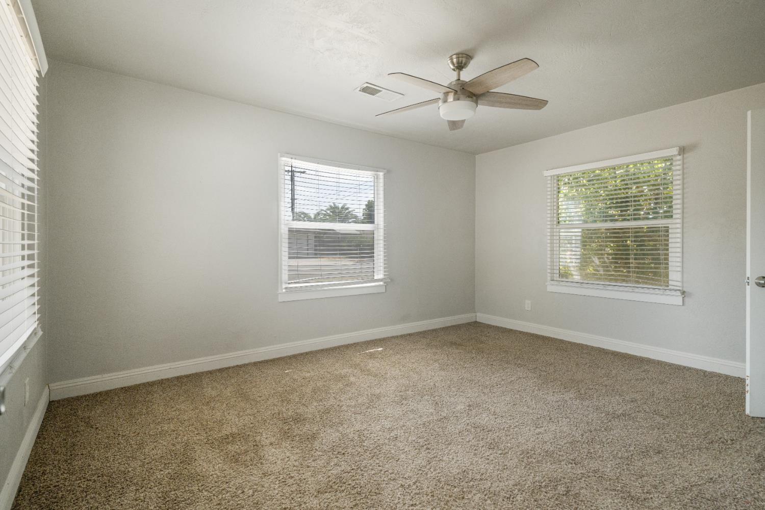 1900 Easy Street Hanford, CA 93230 - Photo 16 of 23 an empty room with windows and fan