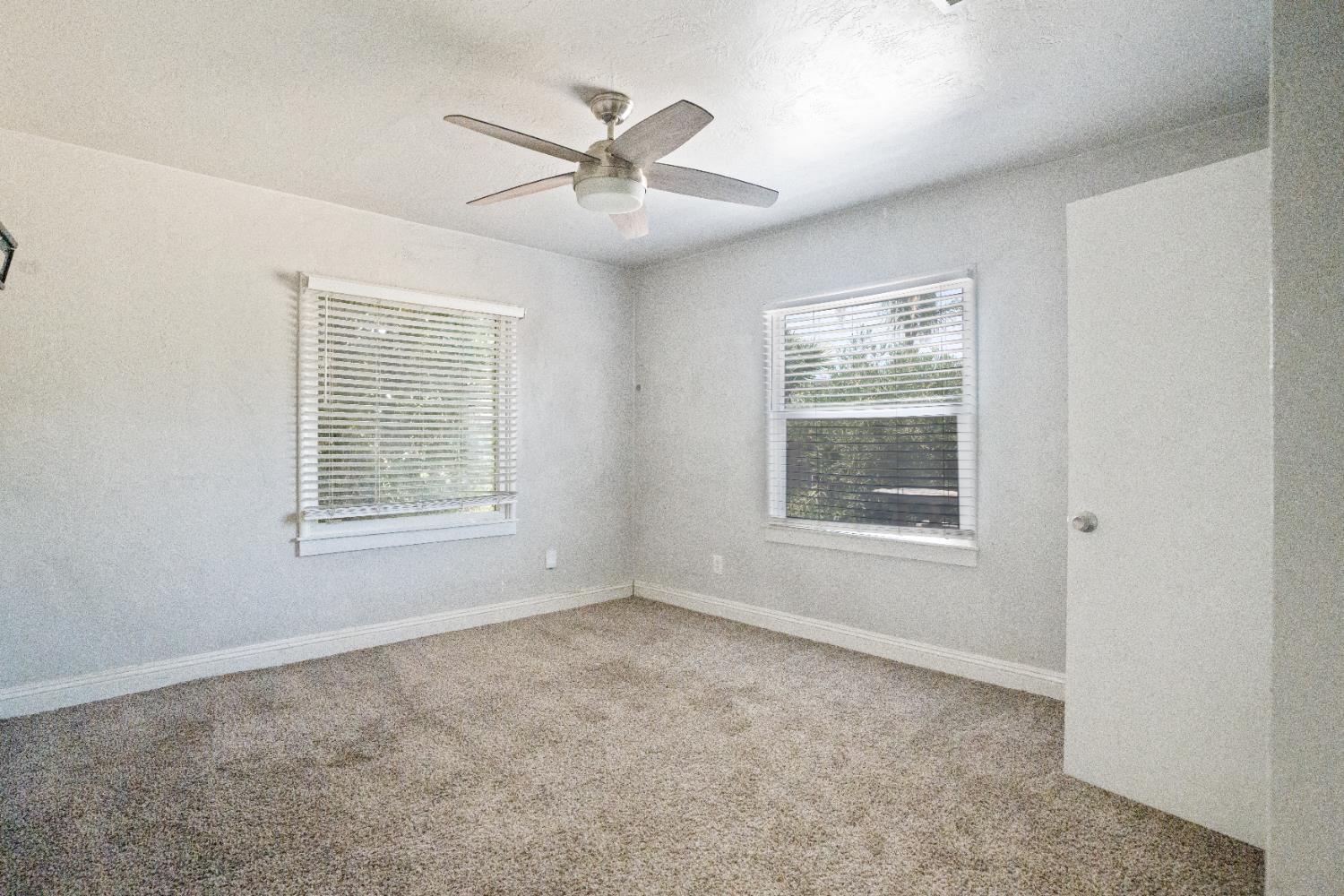 1900 Easy Street Hanford, CA 93230 - Photo 18 of 23 an empty room with windows and fan