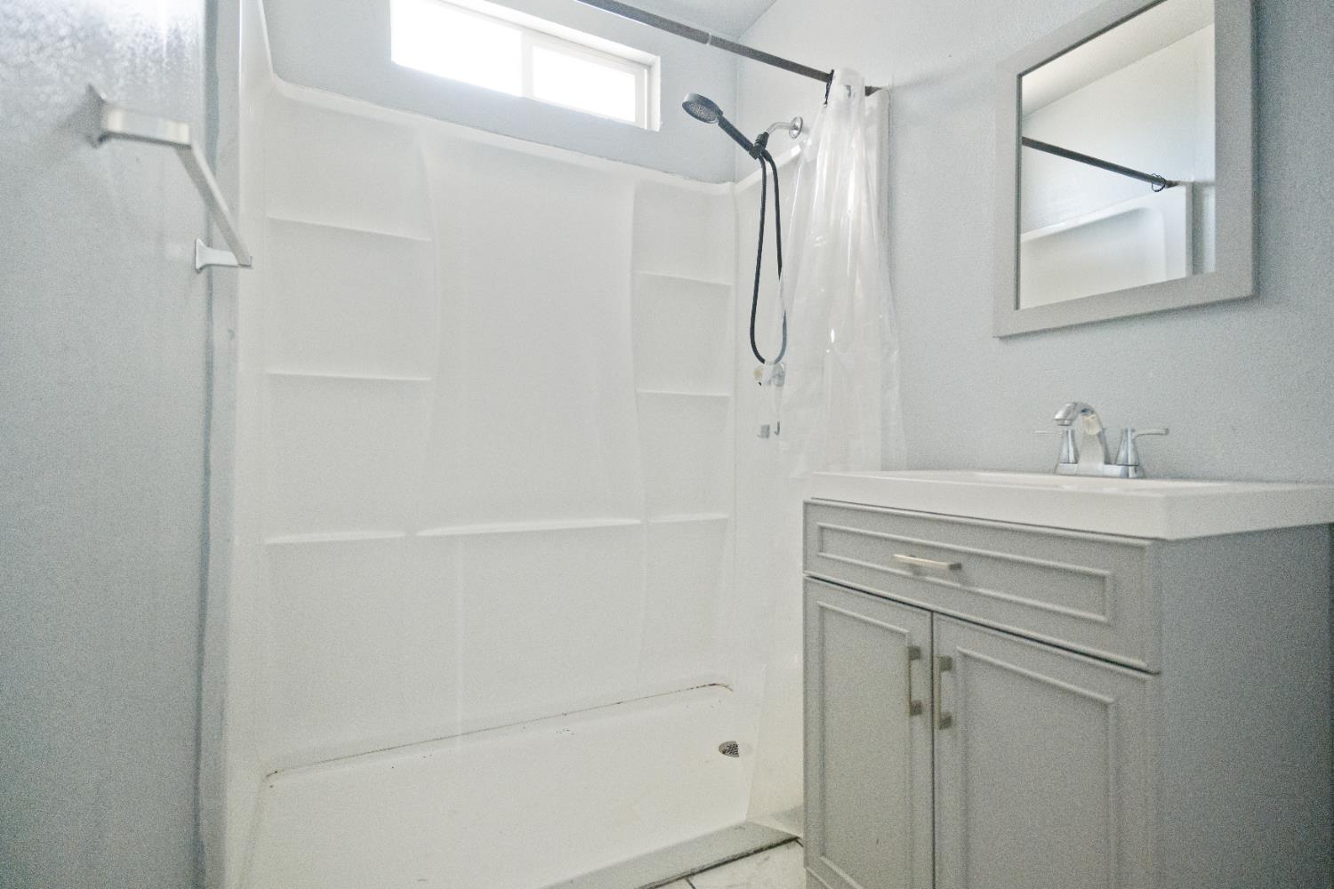 1900 Easy Street Hanford, CA 93230 - Photo 20 of 23 a bathroom with a shower sink vanity and mirror