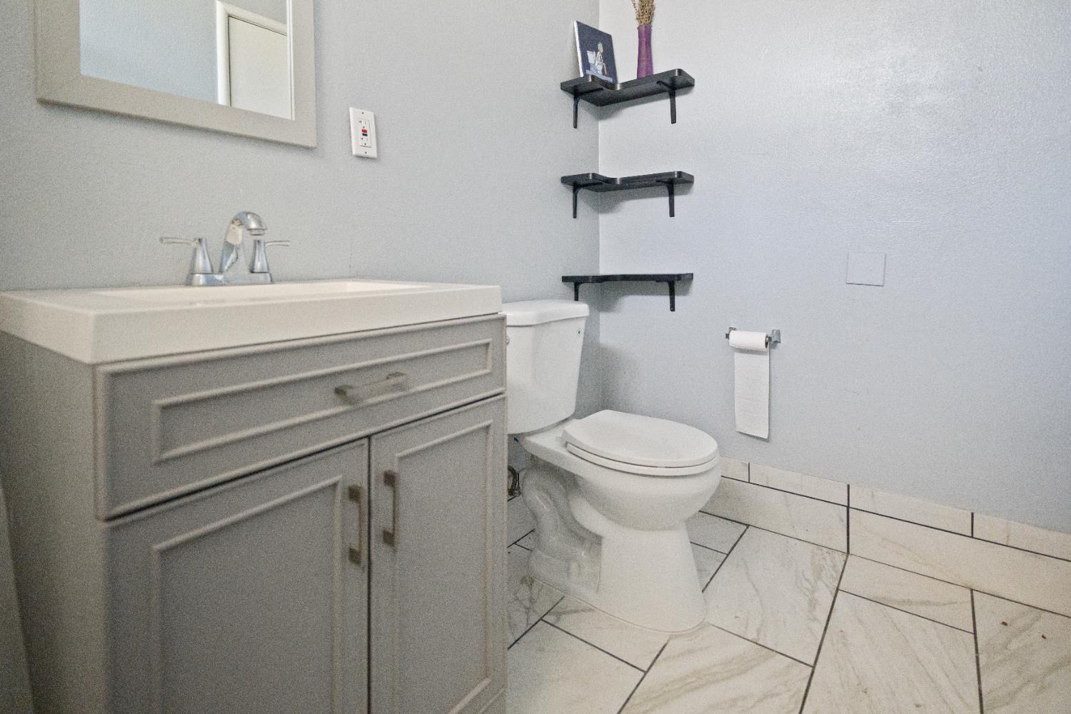 1900 Easy Street Hanford, CA 93230 - Photo 21 of 23 a bathroom with a toilet sink and vanity