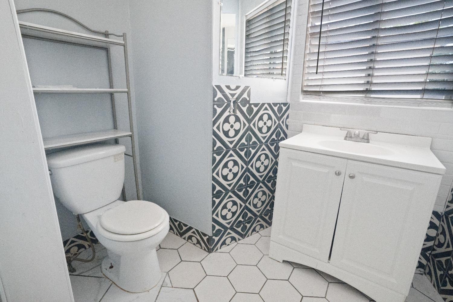 1900 Easy Street Hanford, CA 93230 - Photo 9 of 23 a bathroom with a sink a toilet and a window