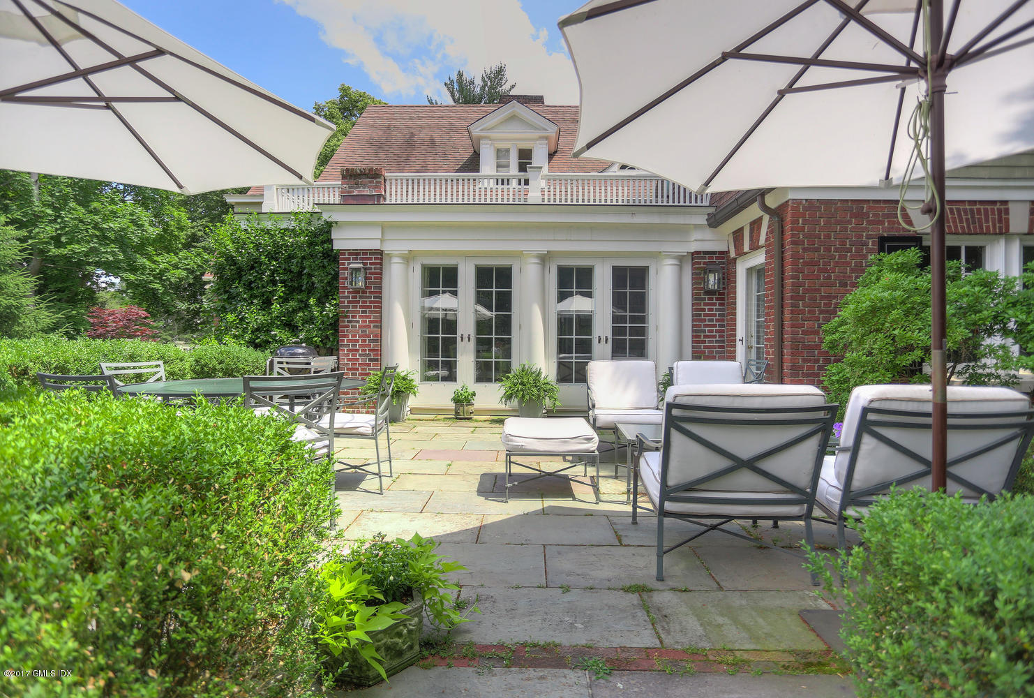 49 Calhoun Drive Greenwich, CT 06831 - Photo 19 of 21 a view of a patio with table and chairs and potted plants