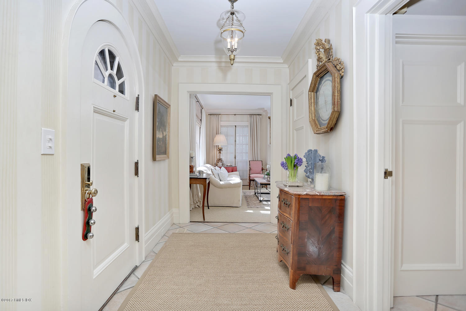 49 Calhoun Drive Greenwich, CT 06831 - Photo 2 of 21 a living room with furniture a mirror and a chandelier