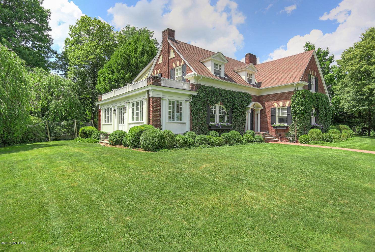 49 Calhoun Drive Greenwich, CT 06831 - Photo 21 of 21 a front view of a house with a yard