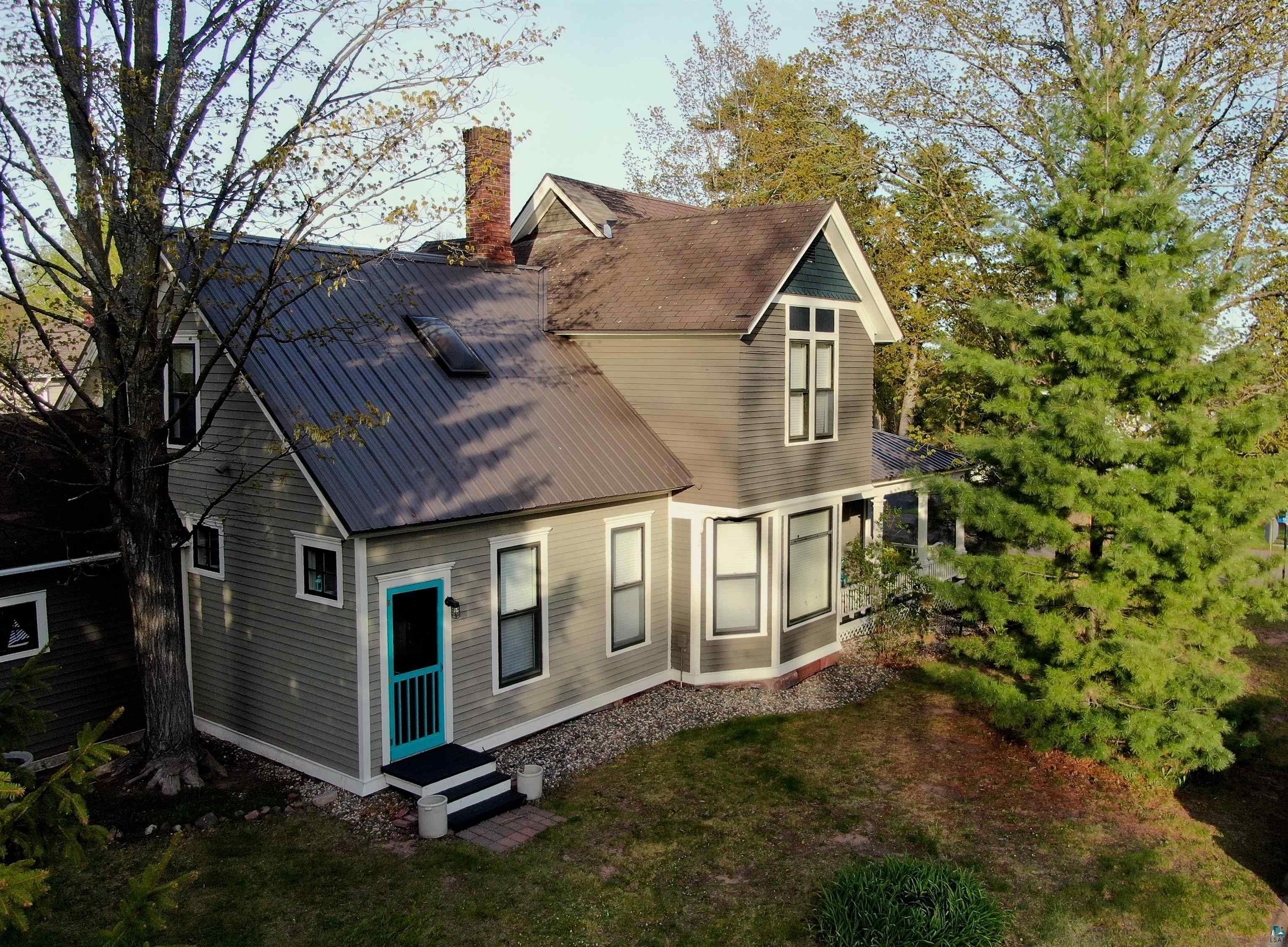 303 East 5th Street Washburn, WI 54891 - Photo 10 of 34 Two-story home featuring gray siding with white trim accents and a dark metal roof