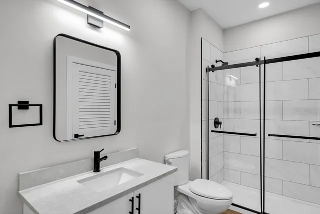 a bathroom with a toilet sink and shower