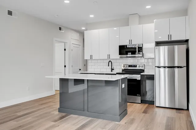 a kitchen with stainless steel appliances a refrigerator stove microwave and sink