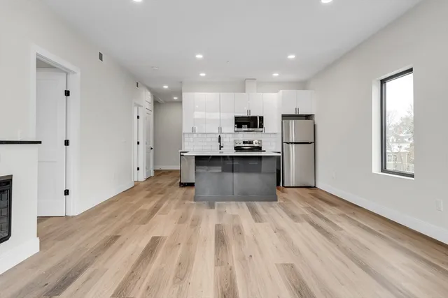 a view of kitchen with wooden floor and electronic appliances