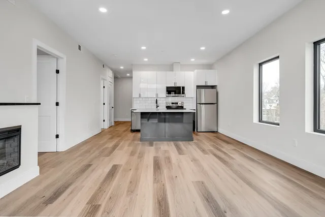 a large kitchen with a lot of counter space and a wooden floor