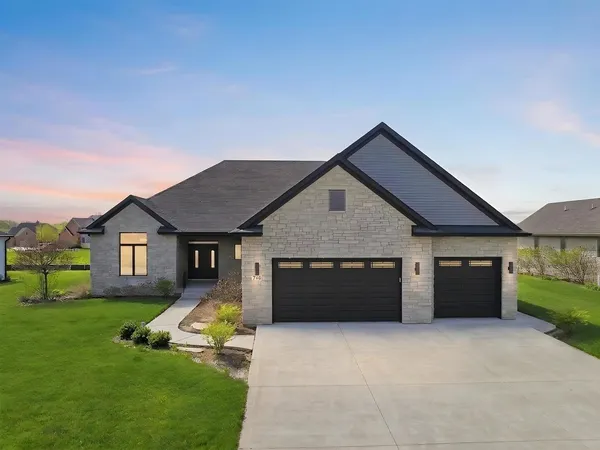 a view of house with a yard and garage