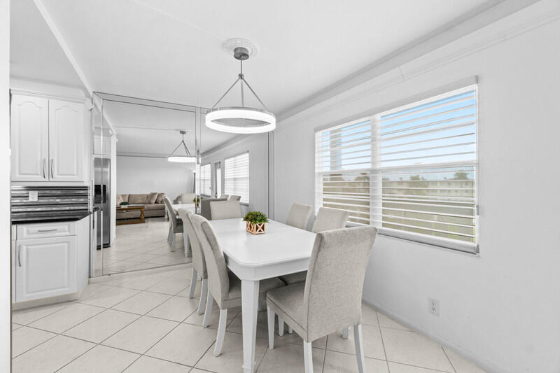 4013 Yarmouth C Boca Raton, FL 33434 - Photo 4 of 16 a kitchen with a chandelier a sink appliances and cabinets