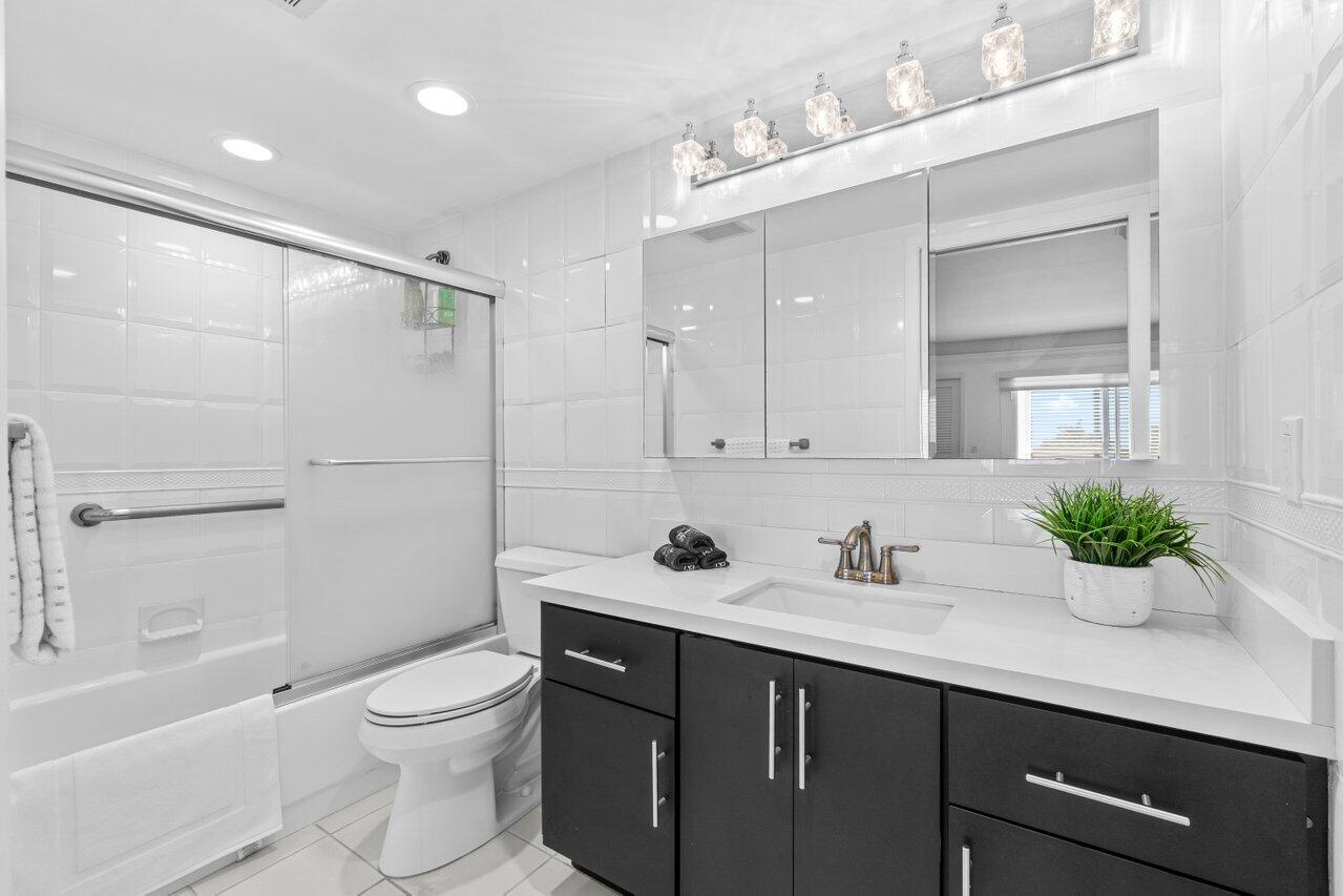 4013 Yarmouth C Boca Raton, FL 33434 - Photo 9 of 16 a bathroom with a sink a toilet and shower