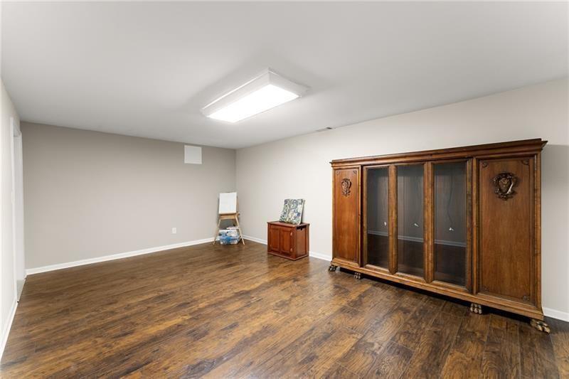 385 Graves Road Acworth, GA 30101 - Photo 31 of 61 an empty room with wooden floor and windows