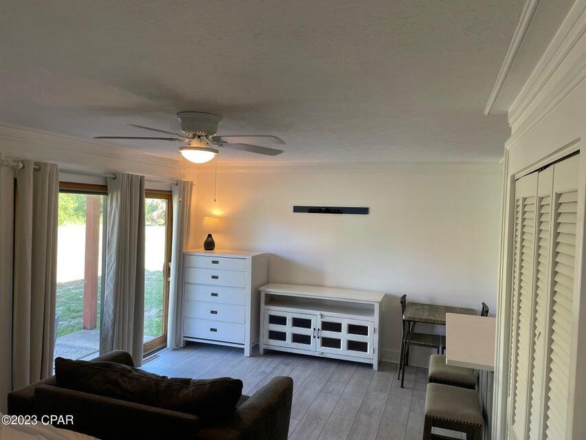 101 Cain Road, Unit B Panama City Beach, FL 32413 - Photo 5 of 13 a living room with furniture and a flat screen tv