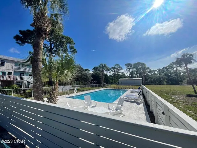a view of a swimming pool with an outdoor seating
