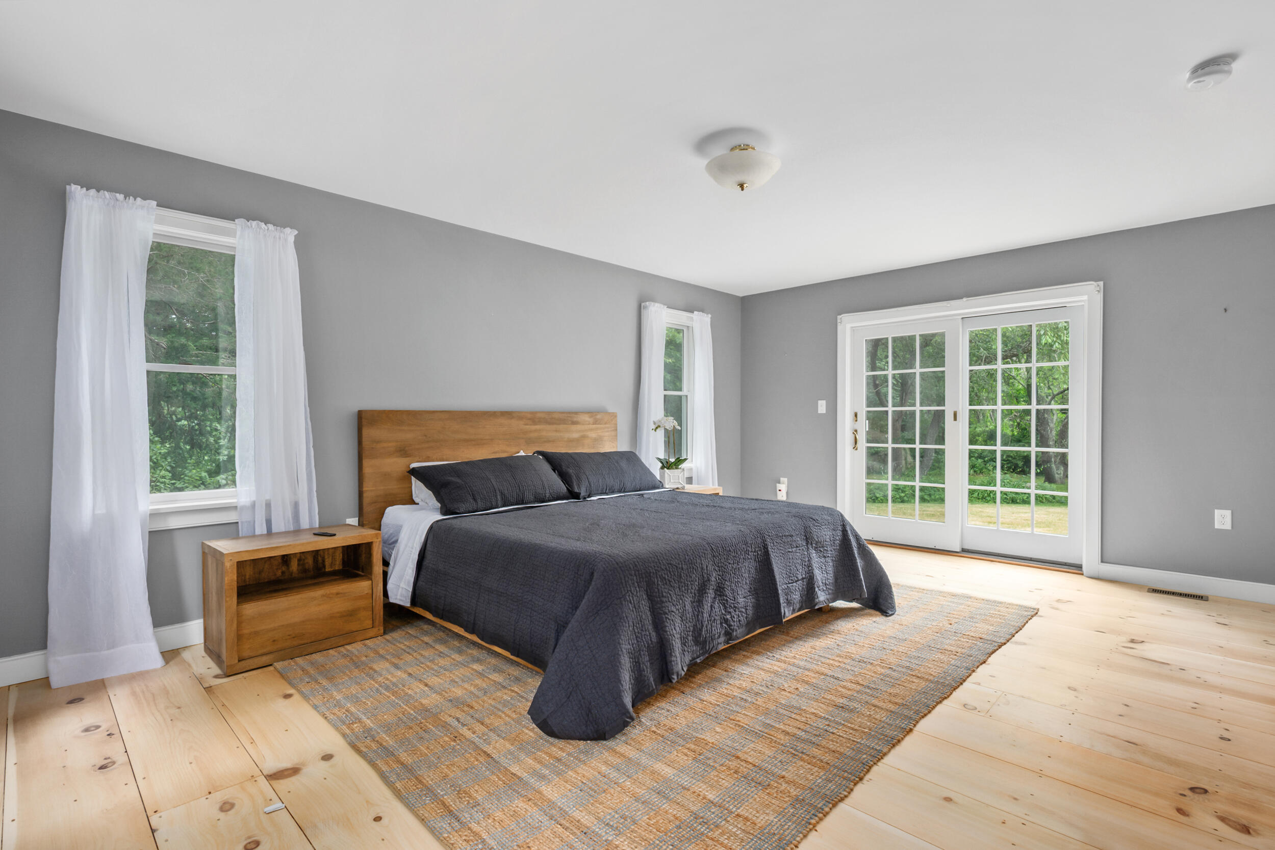 3528 Main Street Barnstable, MA 02630 - Photo 18 of 52 a spacious bedroom with a large bed and a large window