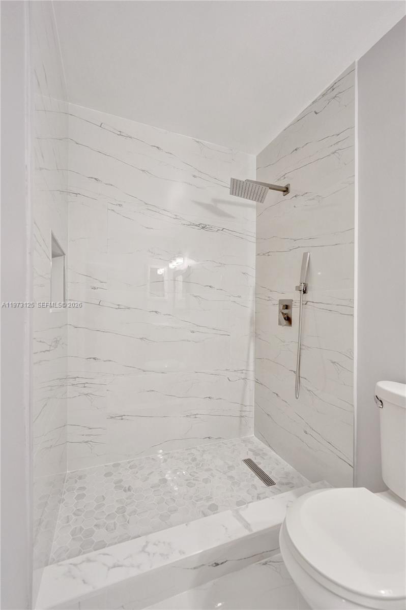 9340 Southwest 61st Way, Unit B Boca Raton, FL 33428 - Photo 16 of 25 a bathroom with a shower and toilet
