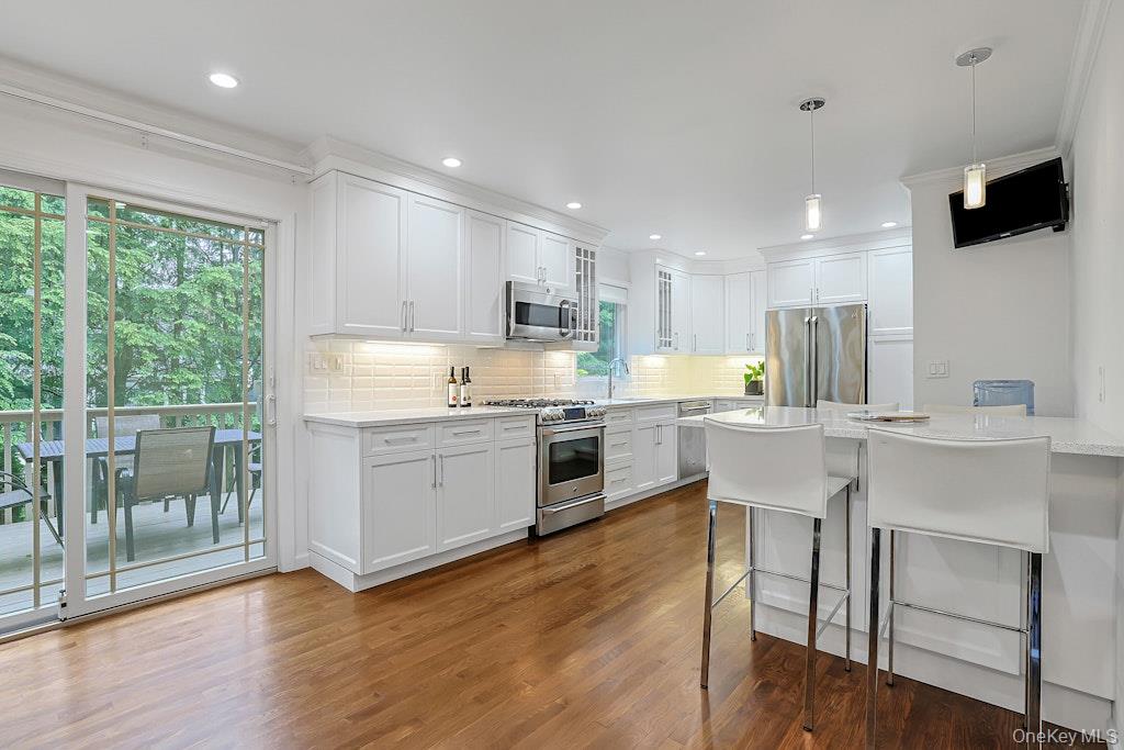 305 Stratton Road New Rochelle, NY 10804 - Photo 5 of 32 a kitchen with a sink cabinets and wooden floor