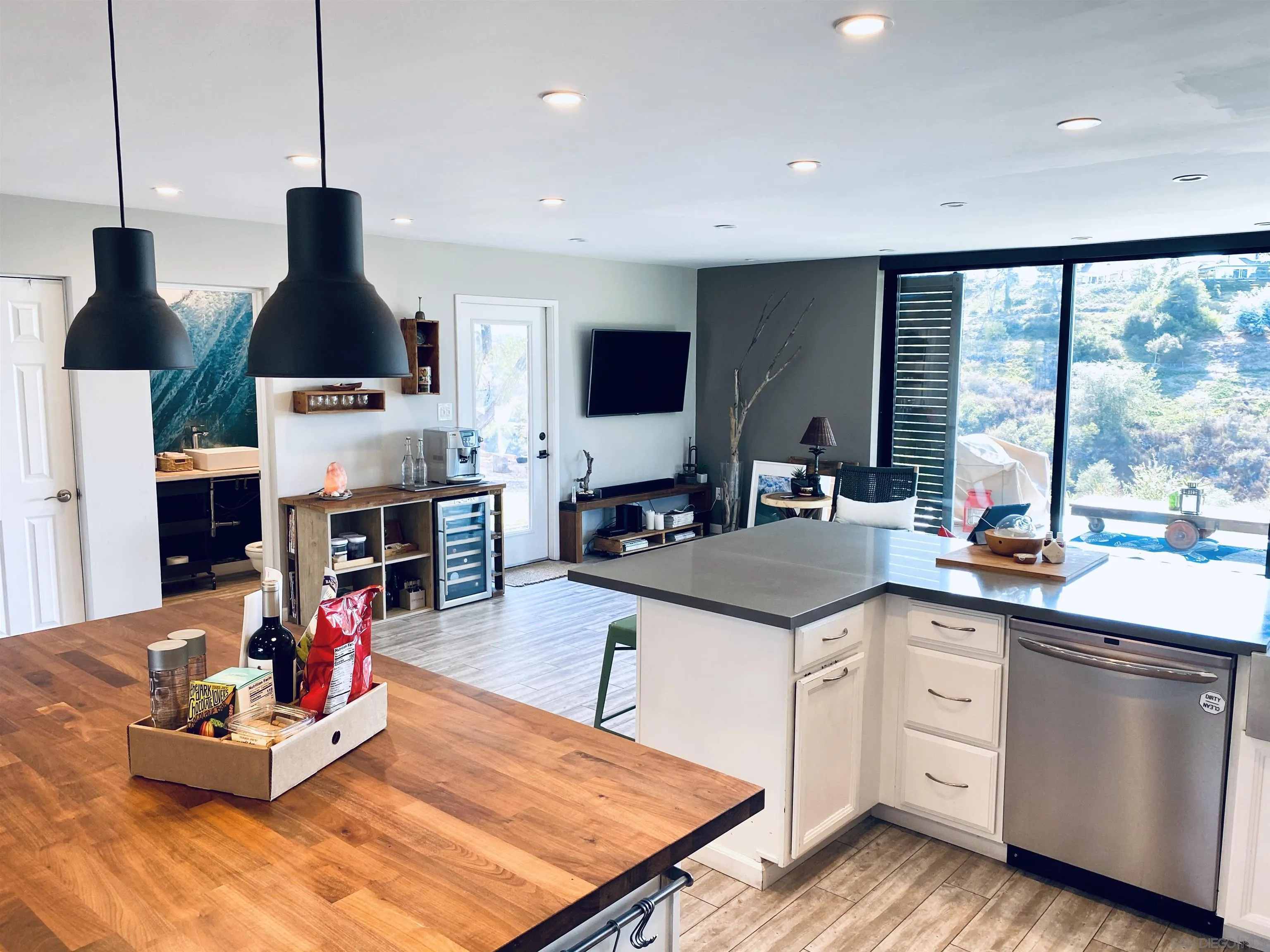 5560 Diane Avenue San Diego, CA 92117 - Photo 11 of 31 a kitchen with stainless steel appliances kitchen island granite countertop a sink and cabinets
