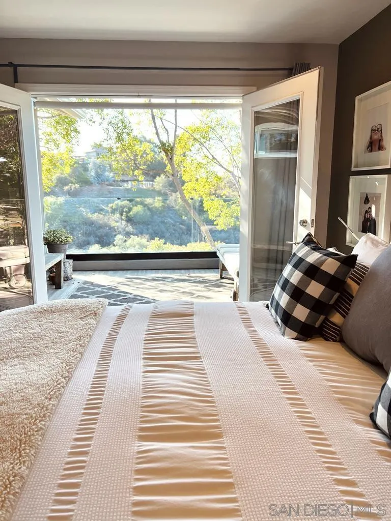 5560 Diane Avenue San Diego, CA 92117 - Photo 18 of 31 a bedroom with a bed and wooden floor