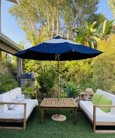 a view of a deck with furniture and a yard
