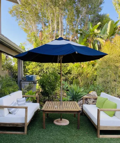 a view of a deck with furniture and a yard
