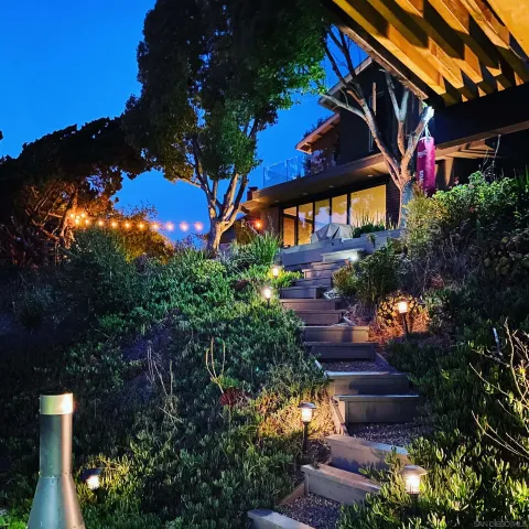 a view of a house with a yard and a pathway