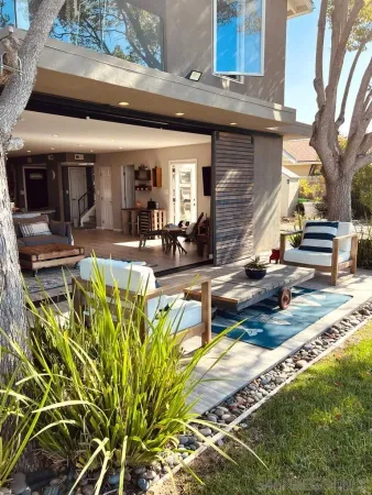 a view of a backyard with plants and patio
