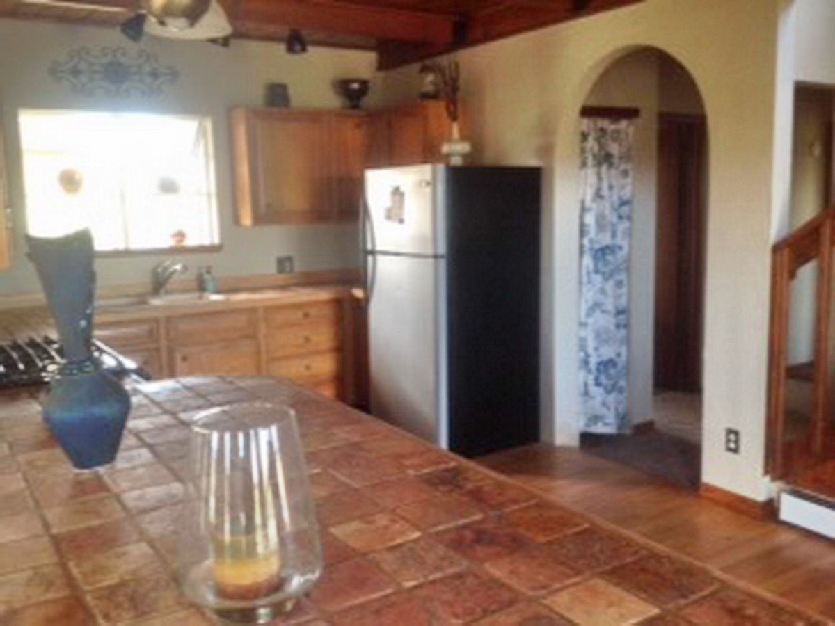 2012 J J 1/2 Road Fruita, CO 81521 - Photo 6 of 36 a kitchen with a refrigerator and a wooden cabinets