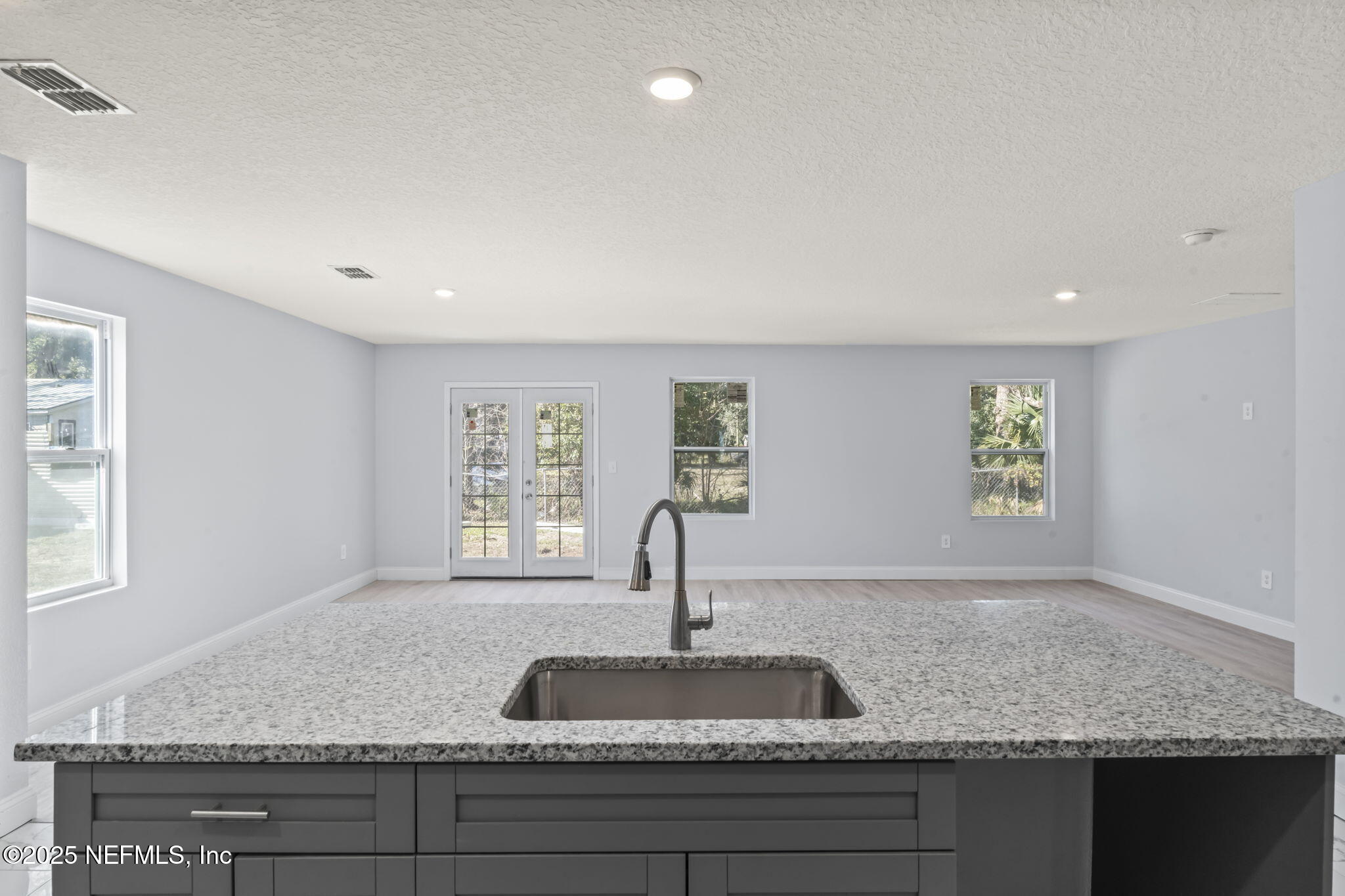 9332 Sisson Drive Jacksonville, FL 32218 - Photo 17 of 42 a kitchen with granite countertop a sink and a window