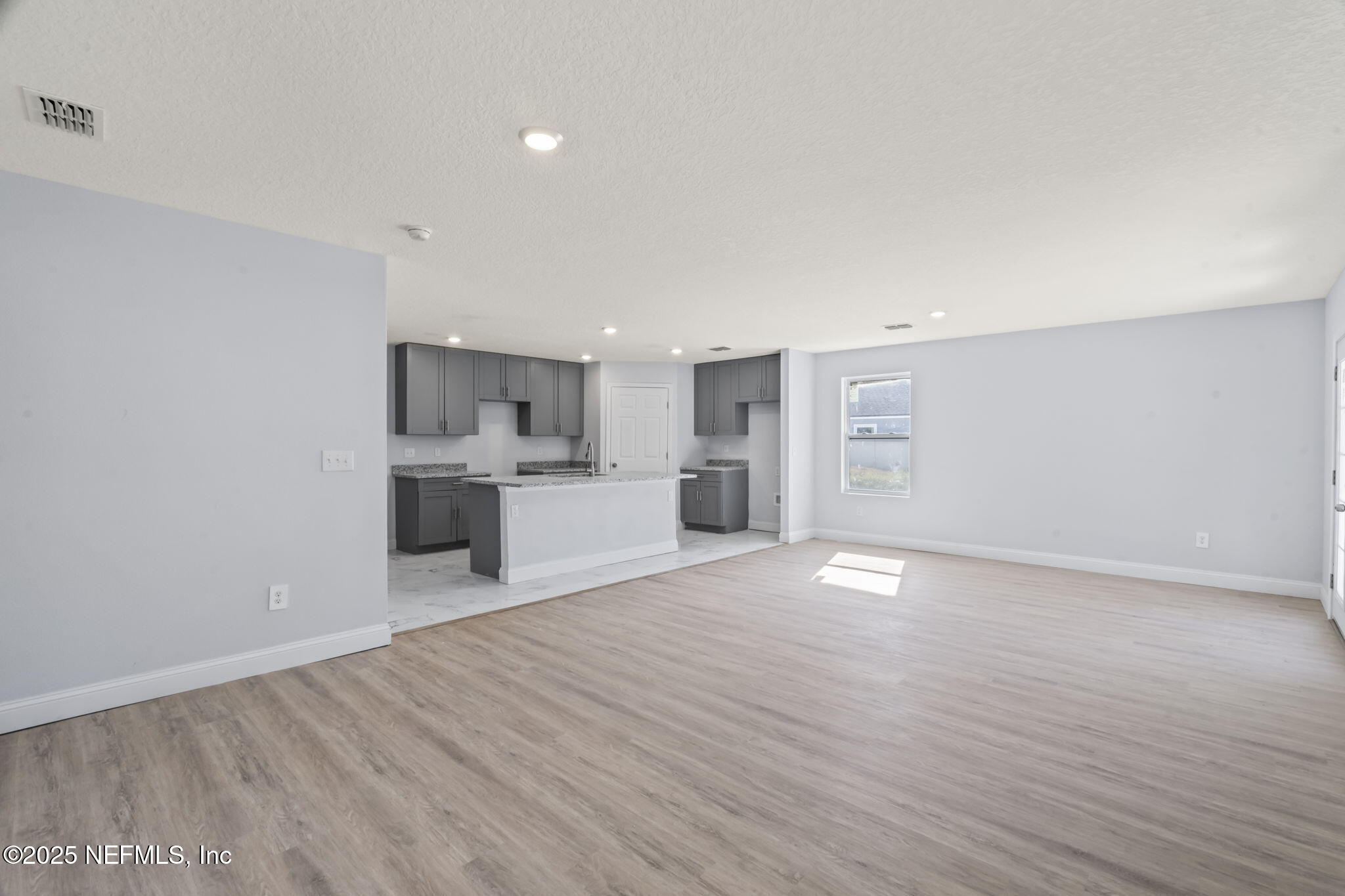 9332 Sisson Drive Jacksonville, FL 32218 - Photo 22 of 42 a view of a kitchen with a sink and dishwasher a refrigerator with wooden floor