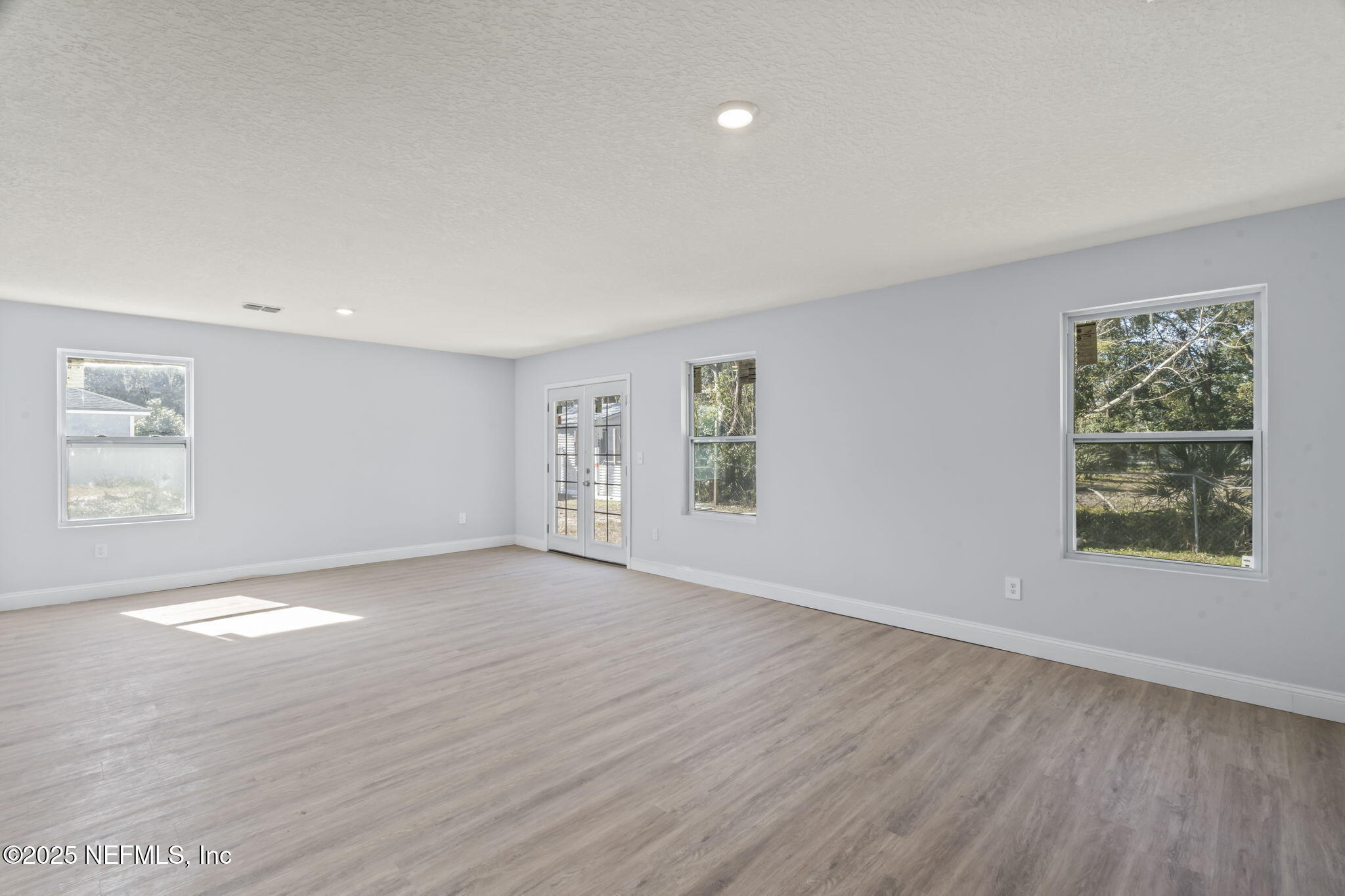 9332 Sisson Drive Jacksonville, FL 32218 - Photo 23 of 42 wooden floor in an empty room with a window