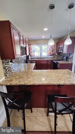a kitchen with granite countertop sink and cabinets