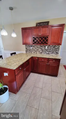 a kitchen with stainless steel appliances granite countertop wooden cabinets a oven and granite counter tops