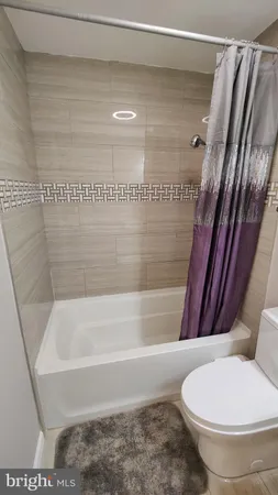 a bathroom with a toilet and a bathtub
