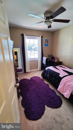 a bedroom with bed and window