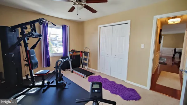 a bedroom with a bed and a couch next to a window
