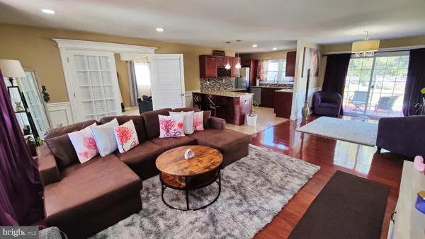 a living room with furniture fireplace and a large window
